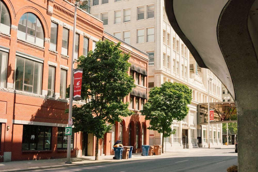 A tree-lined street of historic brick buildings in downtown Spokane